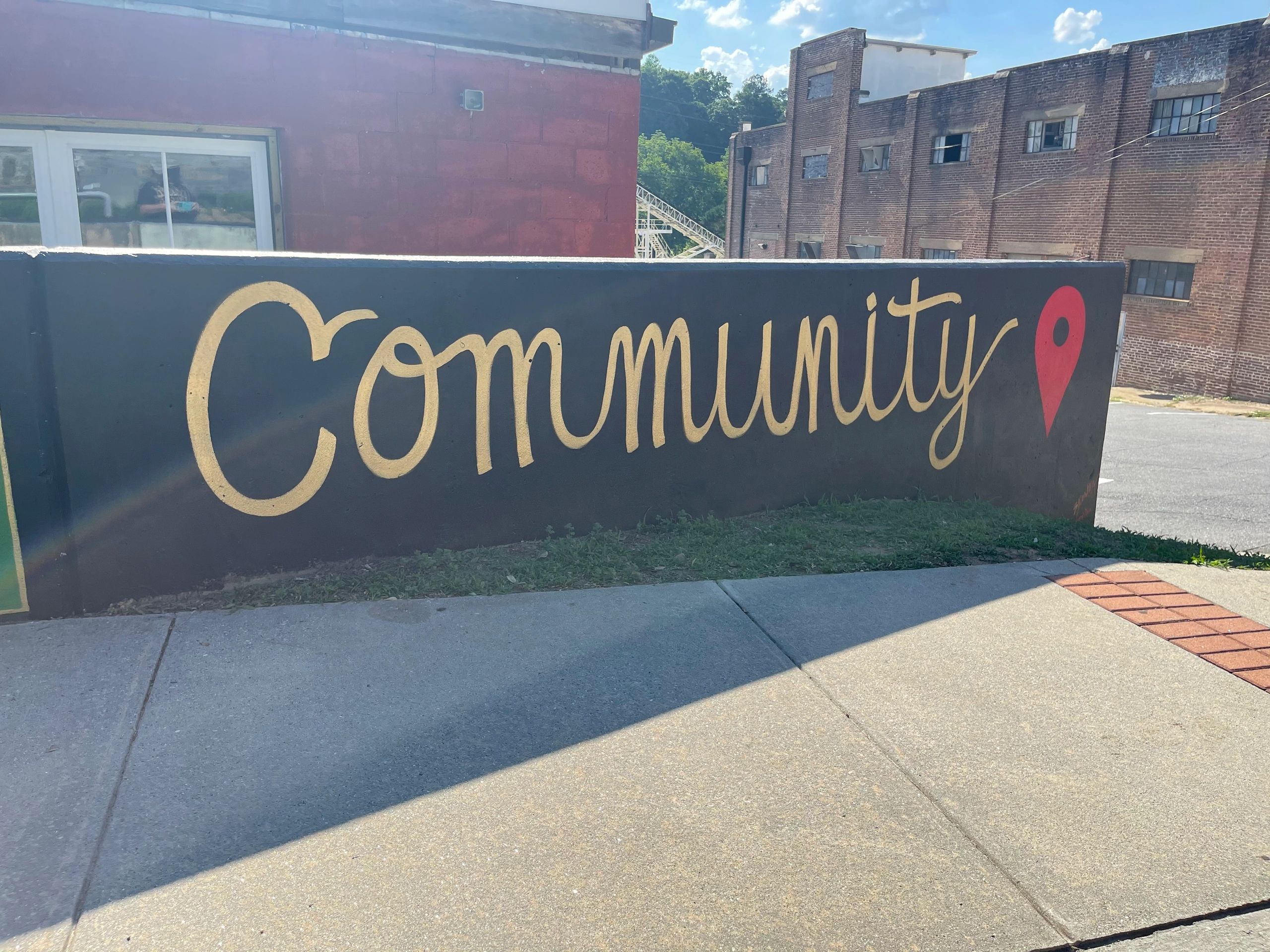 Hand-painted Community sign on a brick wall in Canton