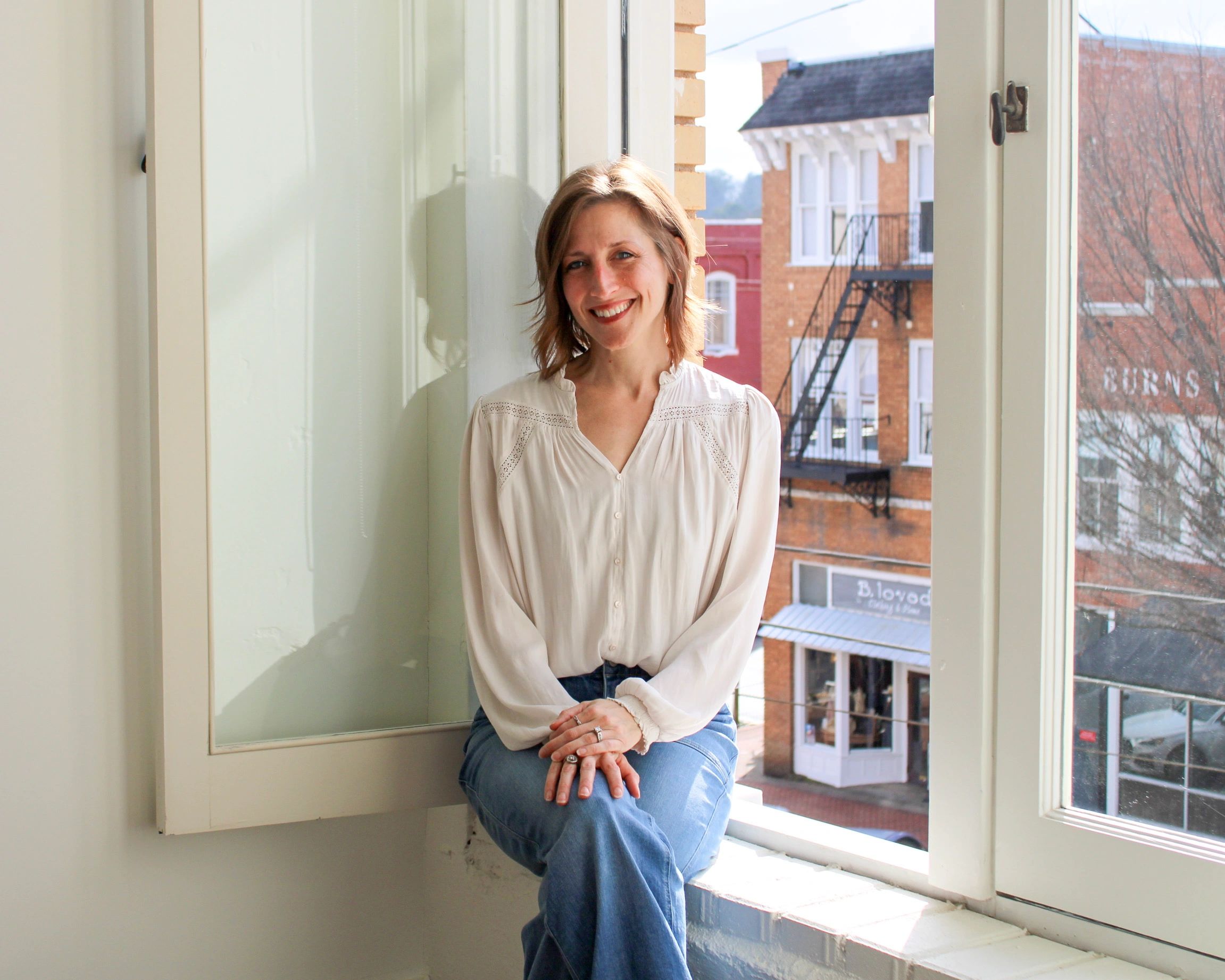 North Georgia artist seated by a studio window