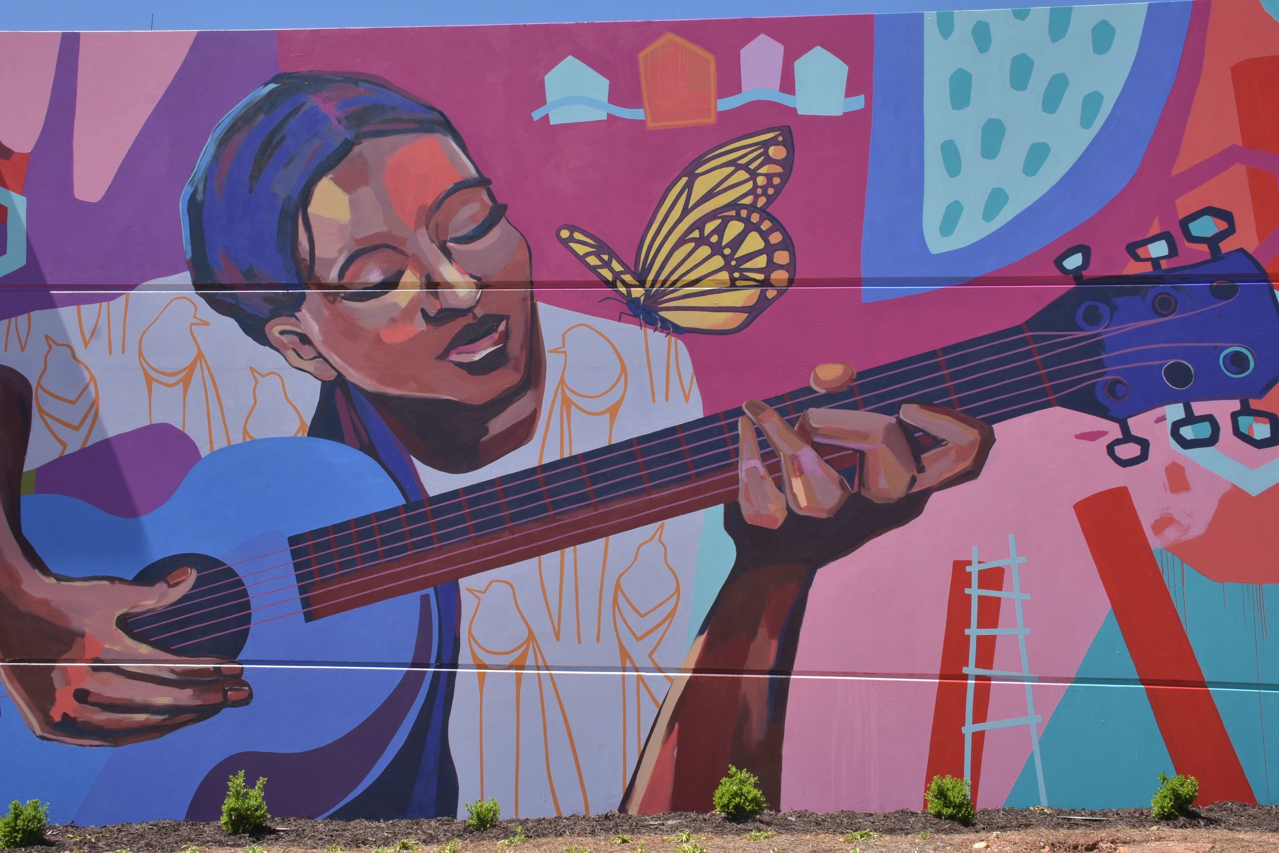 Colorful mural of a guitarist with a butterfly in downtown Canton