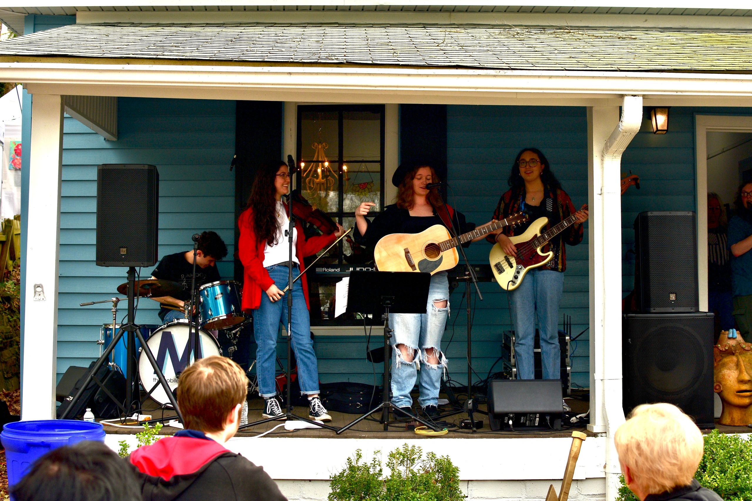 Live band performing on a porch at a Canton arts festival