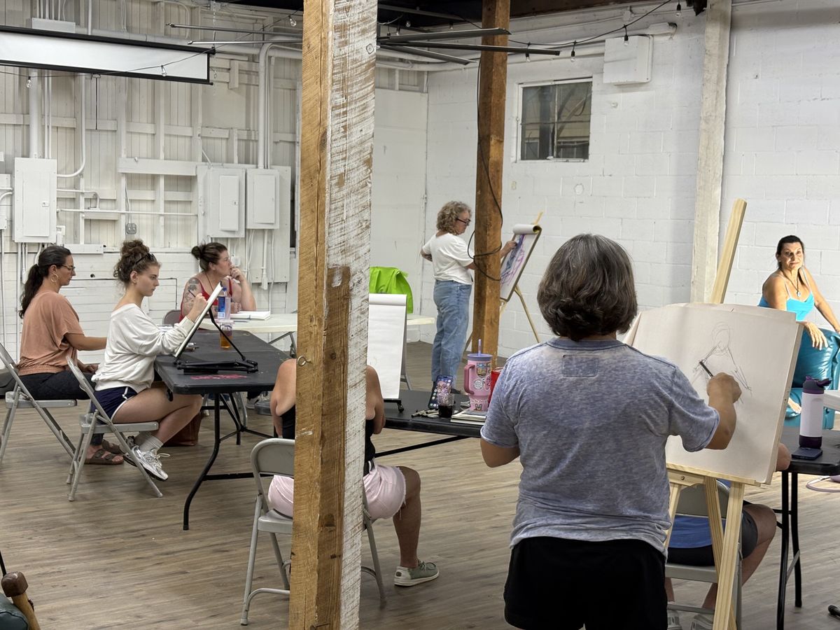 Artists at easels in an Etowah Arts figure drawing class